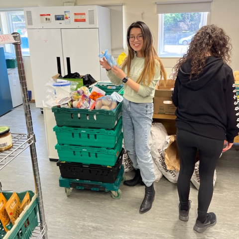 two young women working in the foodbank warehouse