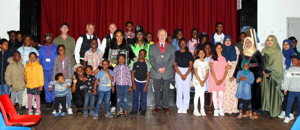 A group of children, staff and VIPs at the end of summer camp event